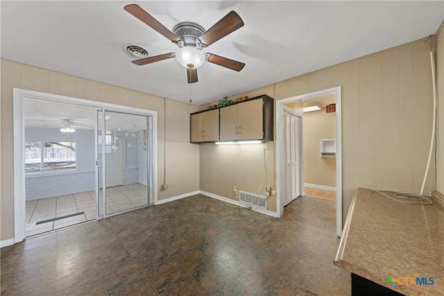 spare room with ceiling fan and visible vents