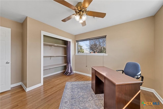 office with a ceiling fan, baseboards, and wood finished floors