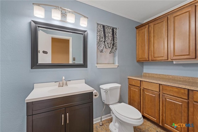 bathroom with ornamental molding, baseboards, vanity, and toilet