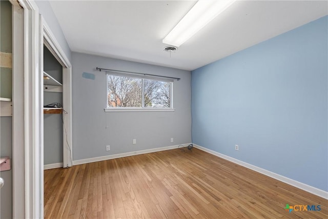 unfurnished bedroom with light wood-type flooring, baseboards, and visible vents