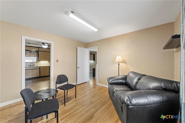 living room featuring baseboards and light wood finished floors