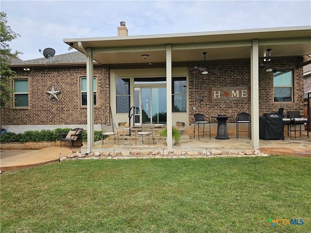 1169 Creek Cyn, New Braunfels, TX 78132 - rear view of house with brick siding, a yard, a patio, and a chimney