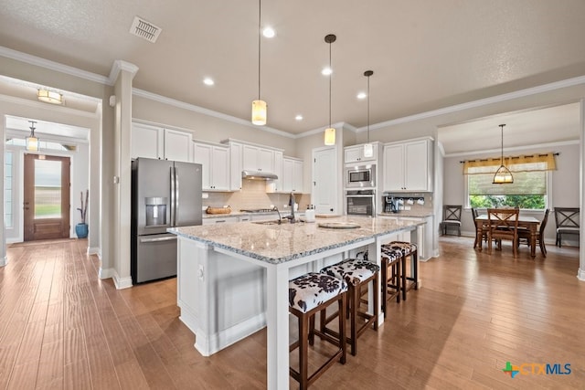 1169 Creek Cyn, New Braunfels, TX 78132 - kitchen featuring appliances with stainless steel finishes, white cabinets, tasteful backsplash, a sink, and recessed lighting