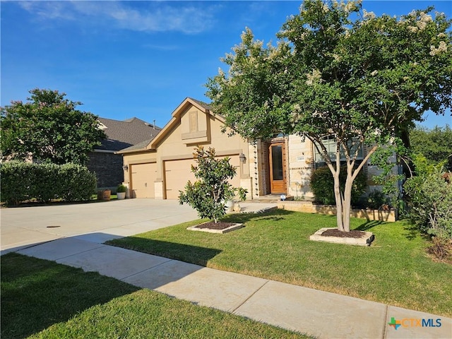 1169 Creek Cyn, New Braunfels, TX 78132 - view of front of home featuring a front lawn, an attached garage, driveway, and stucco siding