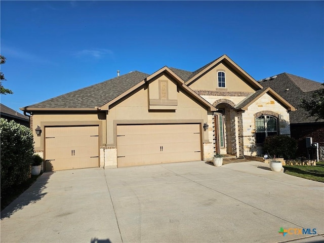 1169 Creek Cyn, New Braunfels, TX 78132 - view of front facade featuring stone siding, driveway, stucco siding, and a garage