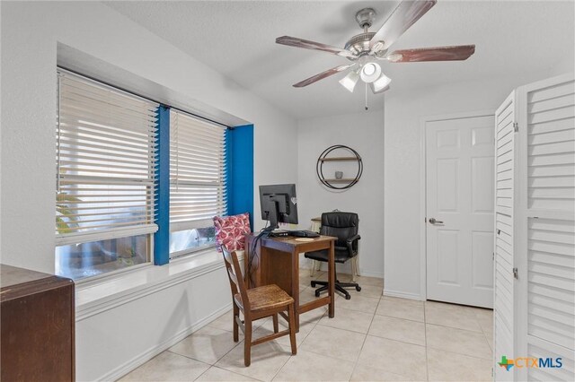 home office with ceiling fan and light tile patterned flooring
