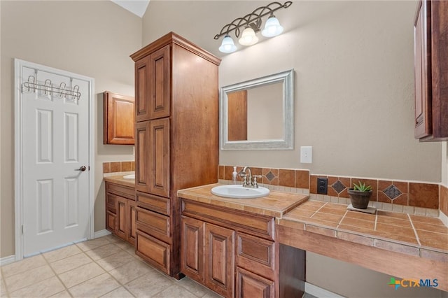 bathroom with tile patterned floors and double vanity