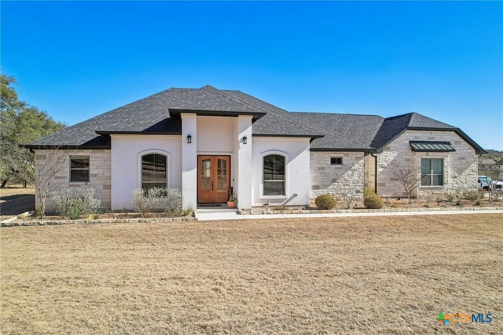 view of front of home with french doors and a front yard