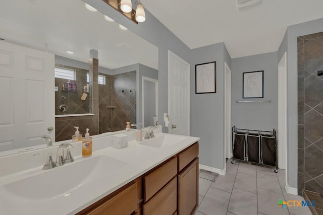 bathroom featuring double vanity, a walk in shower, baseboards, and a sink