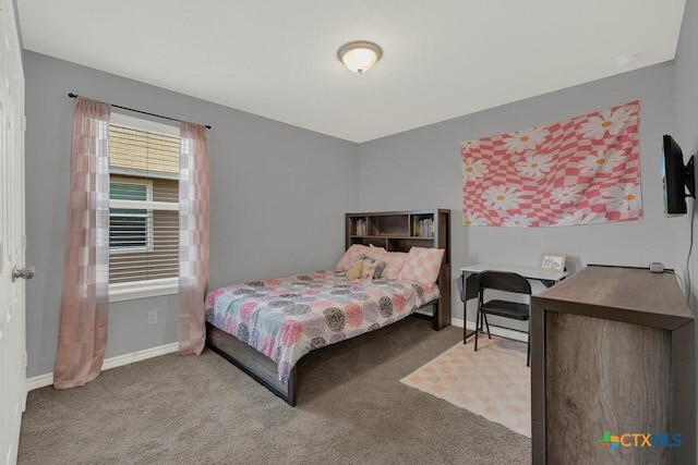 bedroom with carpet and baseboards