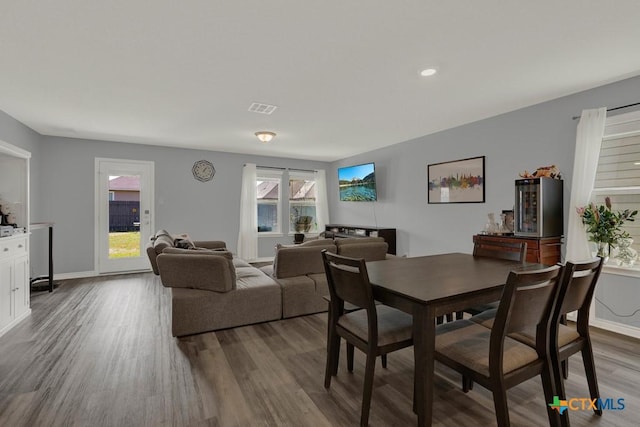 dining room with visible vents, baseboards, and dark wood-style floors