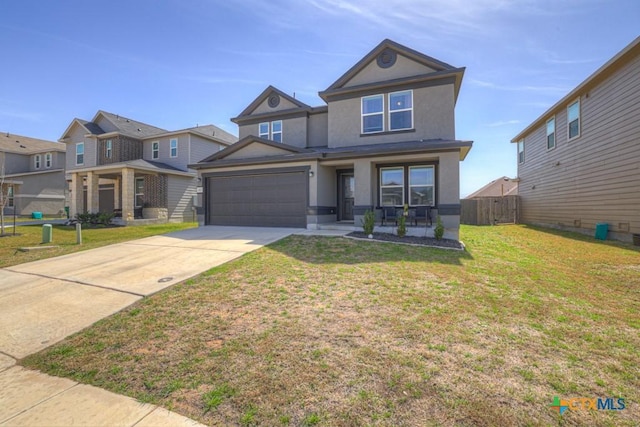 view of front of home with a front lawn, an attached garage, driveway, and stucco siding