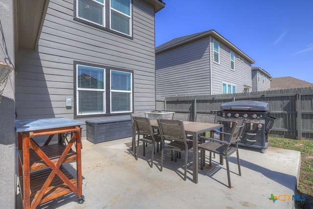 view of patio / terrace with outdoor dining space, area for grilling, and fence