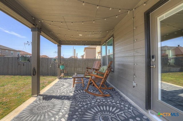 view of patio / terrace featuring fence