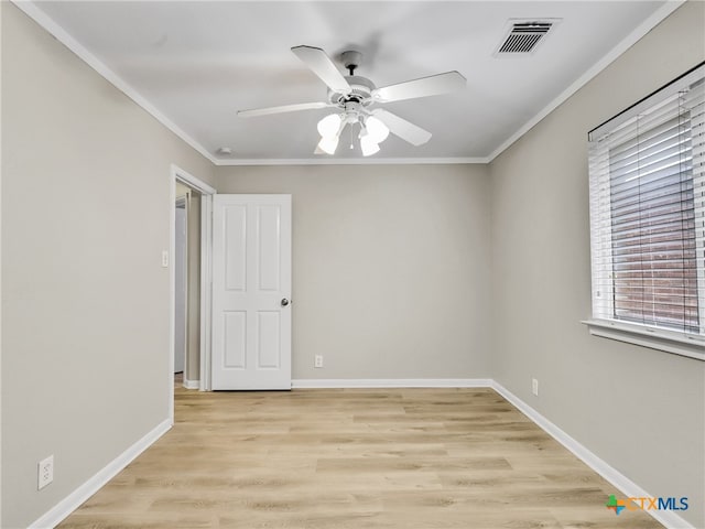 empty room with ceiling fan, light hardwood / wood-style floors, and ornamental molding