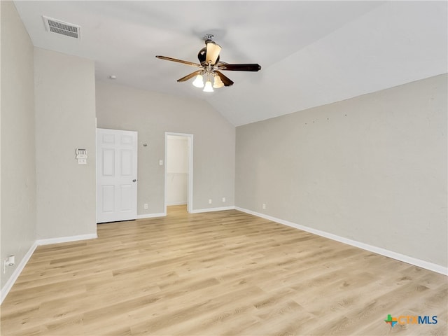 spare room with vaulted ceiling, light hardwood / wood-style flooring, and ceiling fan