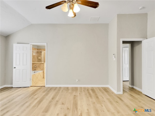 spare room featuring vaulted ceiling, light hardwood / wood-style flooring, and ceiling fan