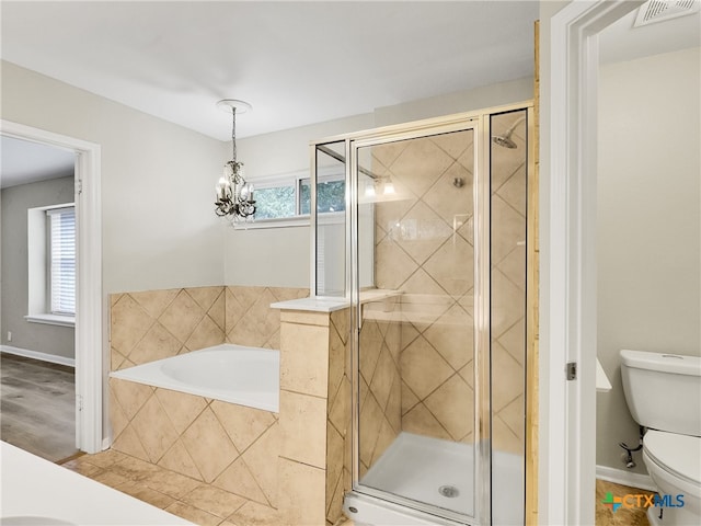 bathroom with hardwood / wood-style floors, separate shower and tub, toilet, and a chandelier