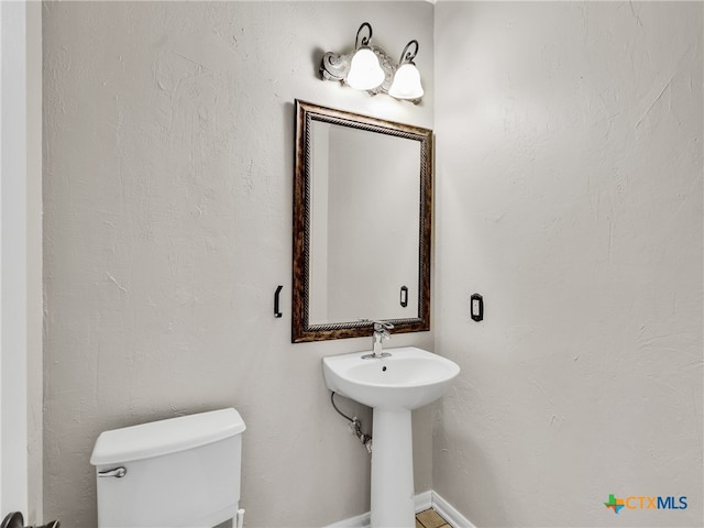 bathroom featuring toilet and sink