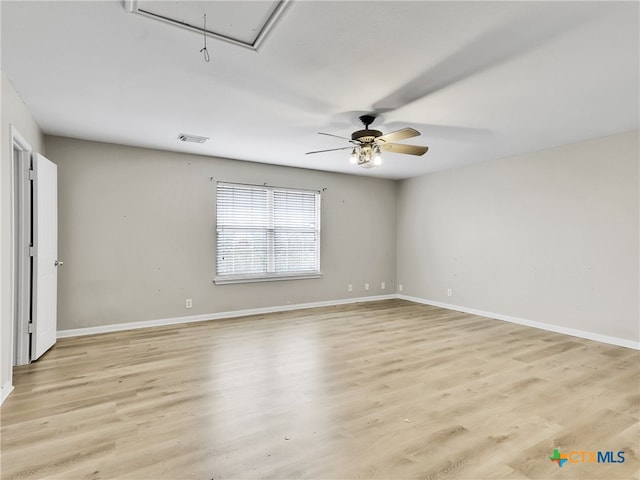 empty room with ceiling fan and light hardwood / wood-style floors