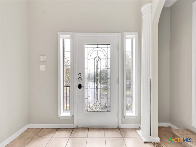 entryway featuring a healthy amount of sunlight and light tile patterned flooring