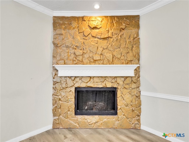 room details with a fireplace, wood-type flooring, and crown molding