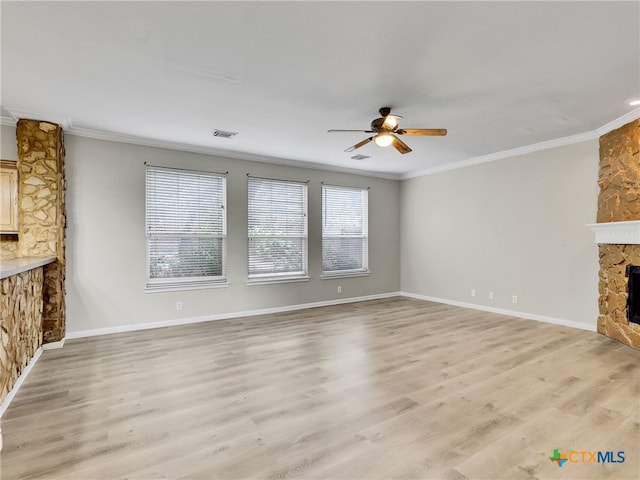 unfurnished living room featuring a stone fireplace, ceiling fan, light hardwood / wood-style floors, and ornamental molding