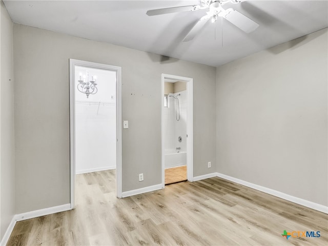 unfurnished bedroom with ensuite bathroom, ceiling fan, a spacious closet, light hardwood / wood-style flooring, and a closet