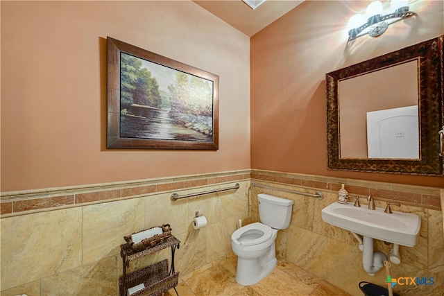 bathroom featuring tile walls and toilet