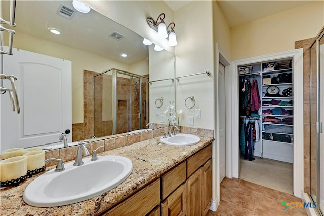 bathroom featuring vanity, tile patterned floors, and walk in shower