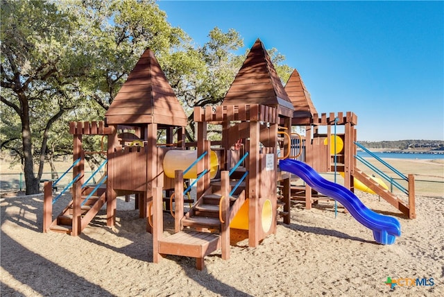 view of playground with a water view