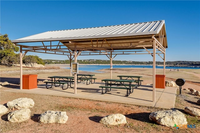 surrounding community with a gazebo and a water view