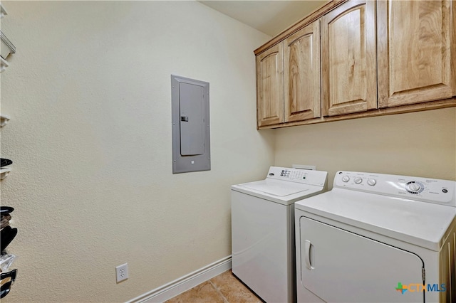 laundry room featuring light tile patterned floors, cabinets, separate washer and dryer, and electric panel