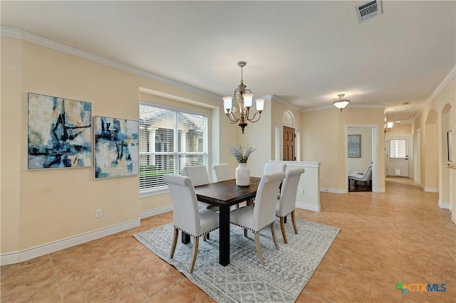 dining area with a chandelier, crown molding, and light tile patterned flooring