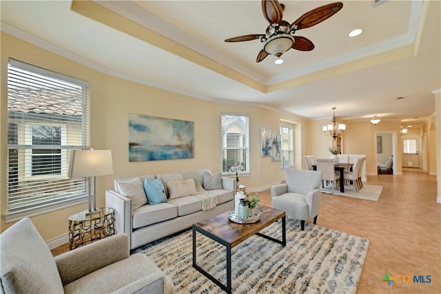 living room with ceiling fan with notable chandelier, a raised ceiling, and crown molding