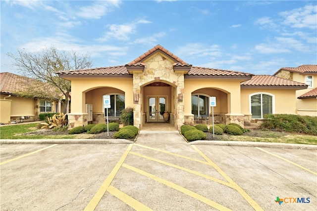 mediterranean / spanish-style home with french doors