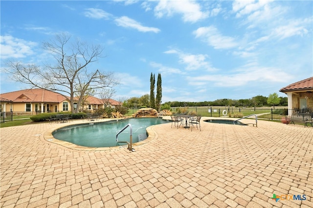 view of pool with a patio area and a community hot tub