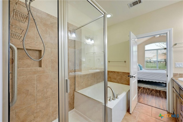 bathroom with tile patterned floors, vanity, and independent shower and bath