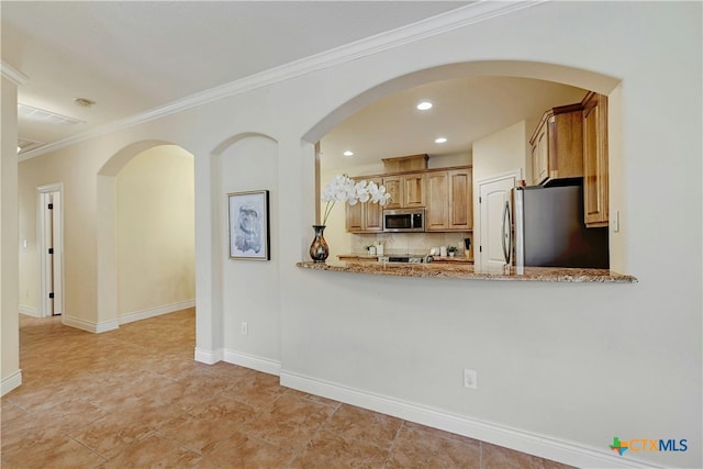 kitchen featuring light stone countertops, stainless steel appliances, kitchen peninsula, and ornamental molding