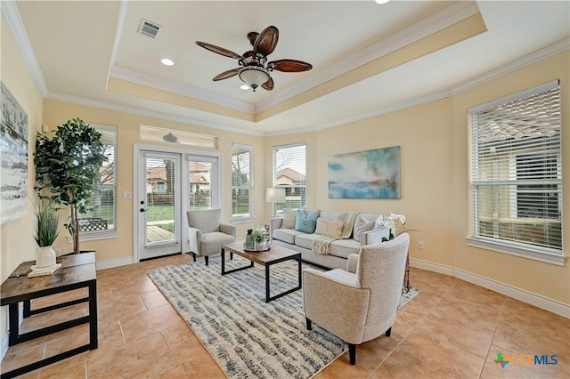 tiled living room with crown molding, ceiling fan, and a healthy amount of sunlight