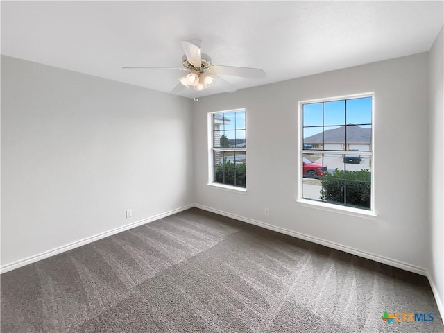 carpeted empty room with ceiling fan