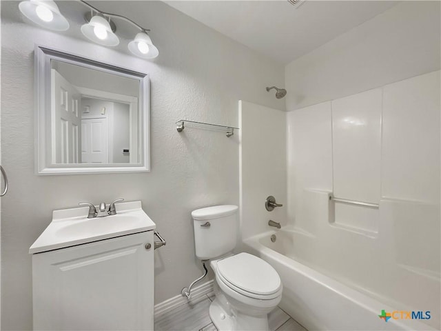 full bathroom with vanity, toilet, and washtub / shower combination