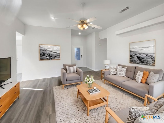 living room featuring ceiling fan and wood-type flooring