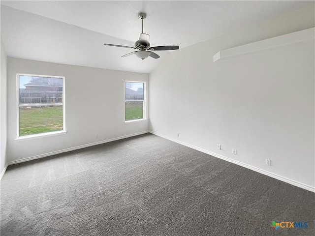 carpeted empty room with ceiling fan and vaulted ceiling