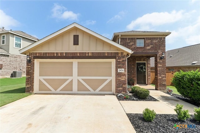 2024 Cowan Dr, New Braunfels, TX 78132 - view of front of property with brick siding, driveway, board and batten siding, an attached garage, and a front lawn