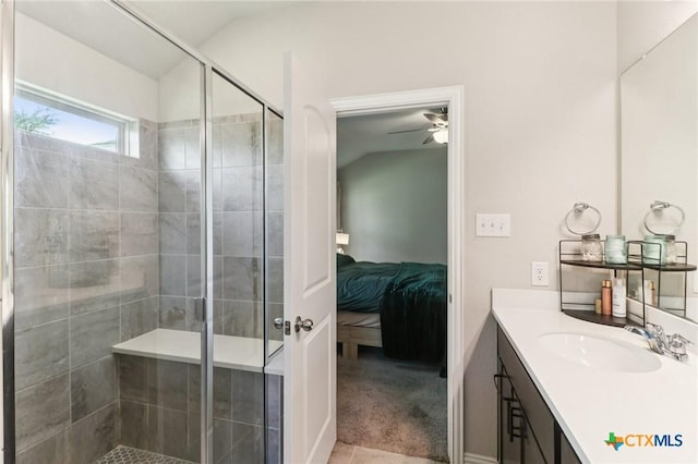 2024 Cowan Dr, New Braunfels, TX 78132 - ensuite bathroom with vanity, a shower stall, ceiling fan, and vaulted ceiling