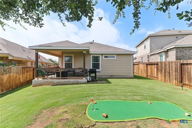 2024 Cowan Dr, New Braunfels, TX 78132 - rear view of property with an area to practice putting and a fenced backyard