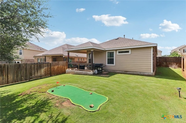2024 Cowan Dr, New Braunfels, TX 78132 - back of property with a fenced backyard, a putting green, and a patio area