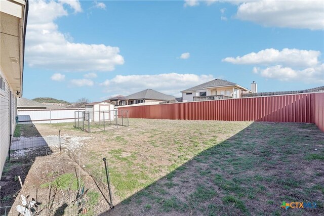 view of yard with an outbuilding and a fenced backyard