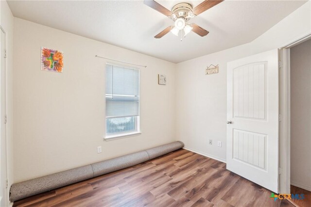 spare room featuring a ceiling fan and wood finished floors